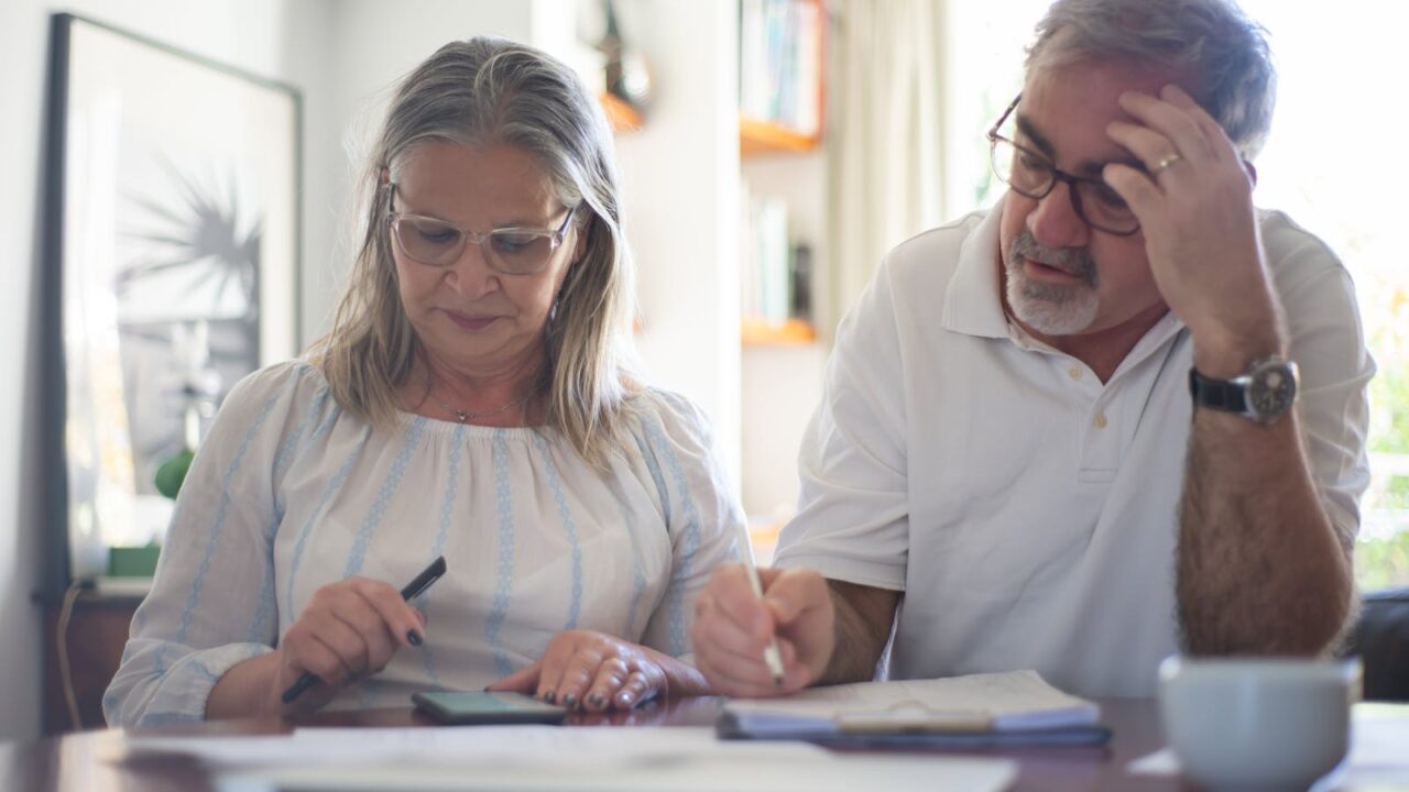 Couple senior comparant PER et assurance vie à la maison